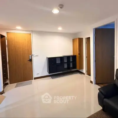 Spacious modern living room with sleek furniture and wooden accents