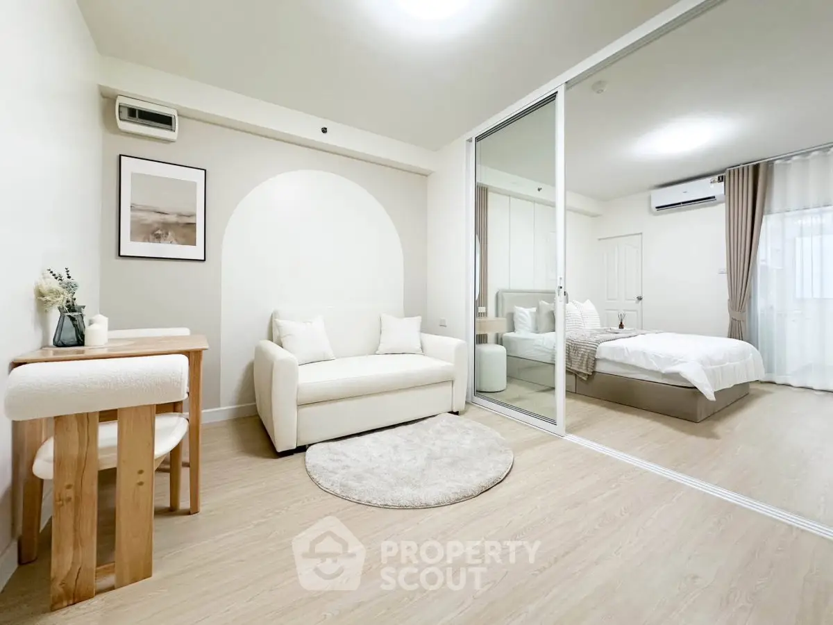 Modern studio apartment with cozy living area and stylish bedroom