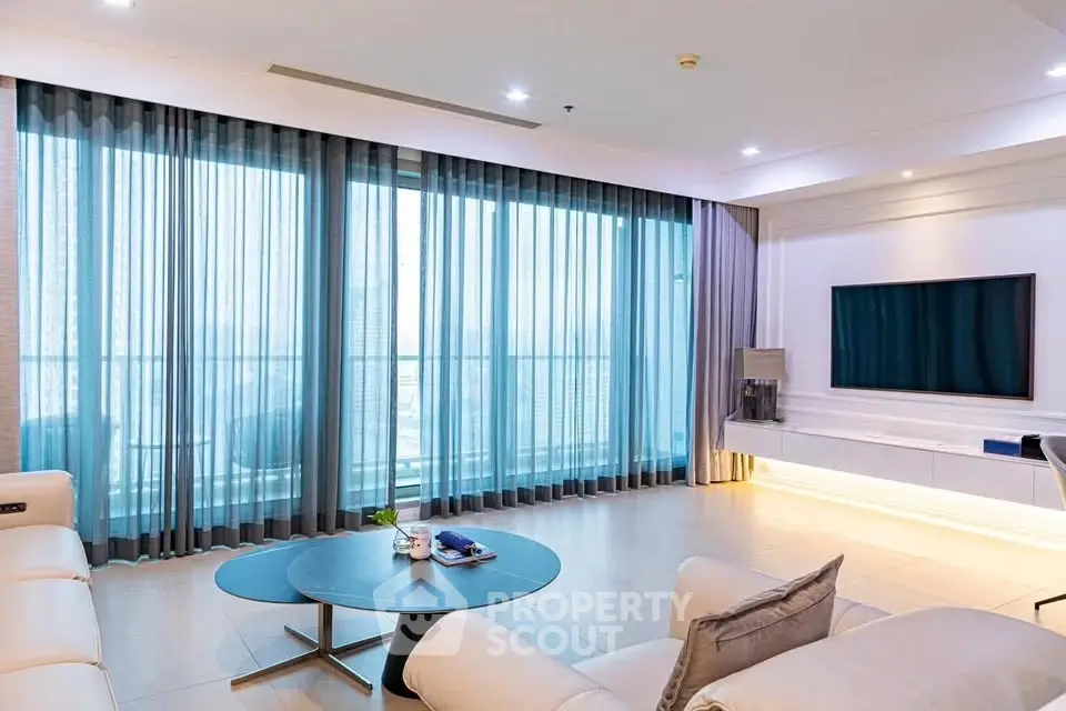 Spacious modern living room with large windows and elegant decor