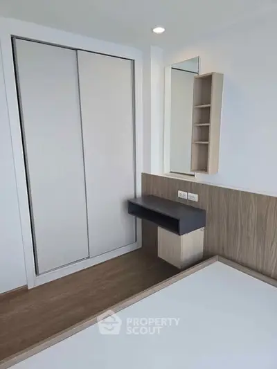 Modern minimalist bedroom with built-in wardrobe and sleek desk