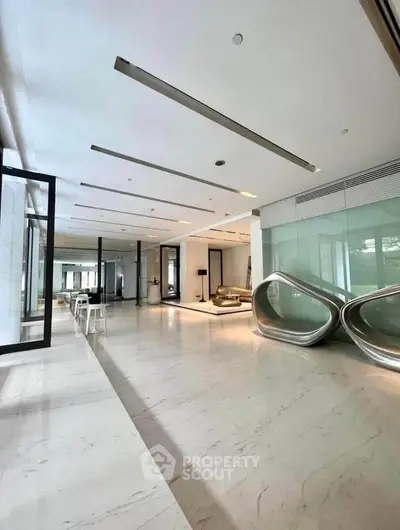 Luxurious modern building lobby with sleek design and stylish seating area.