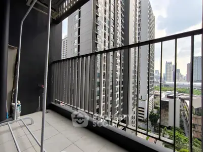 Modern high-rise balcony with cityscape view, perfect for urban living enthusiasts.