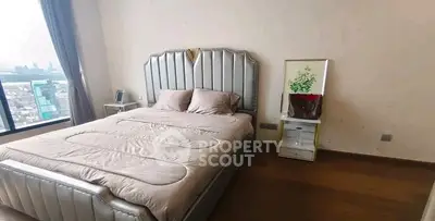 Luxurious bedroom with city view, elegant bed, and stylish decor in modern apartment.