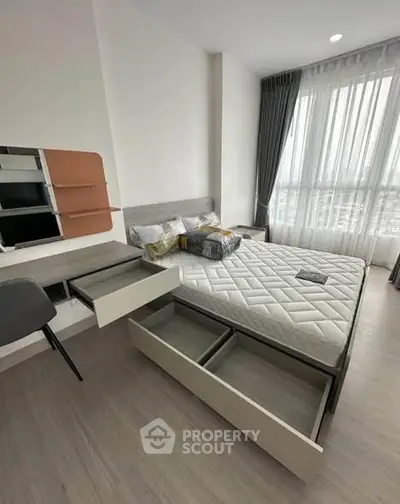 Modern bedroom with storage bed and large window offering natural light