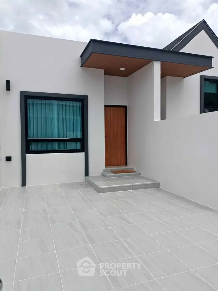 Modern minimalist house exterior with sleek design and spacious driveway.