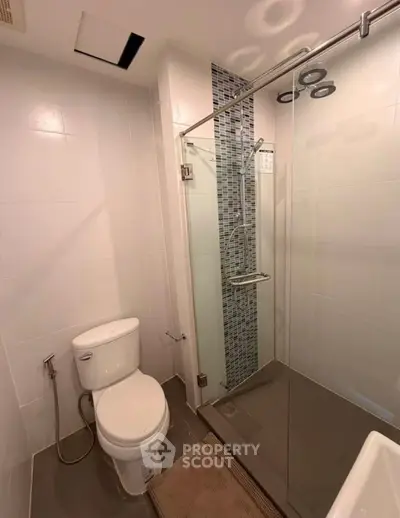 Modern bathroom with glass shower and sleek tile design