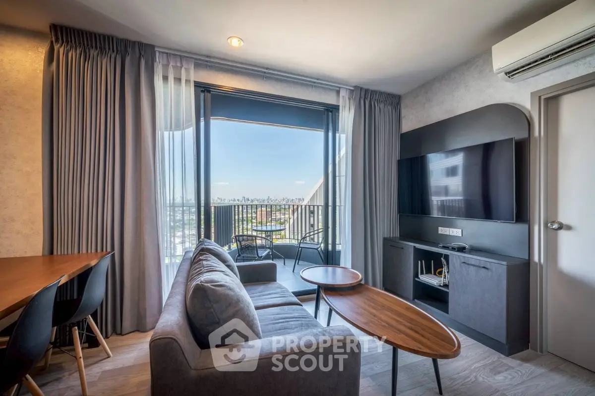 Modern living room with balcony view, stylish furniture, and natural light