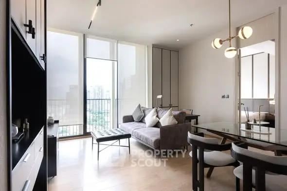 Modern living room with stylish furniture and large windows offering city views.