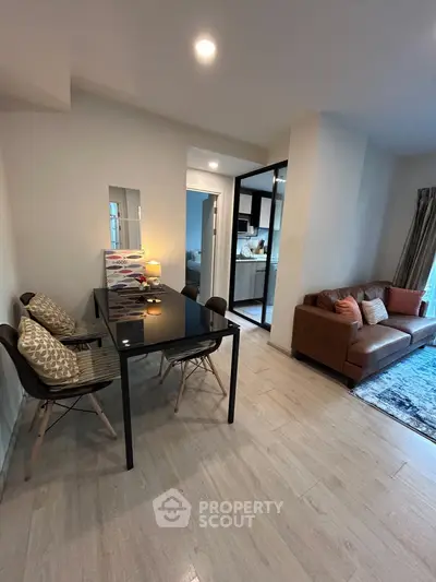 Modern living room with stylish furniture and open kitchen layout