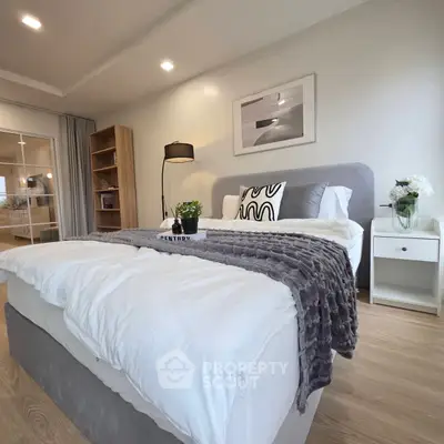 Spacious modern bedroom with stylish decor and cozy ambiance