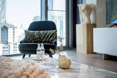 Luxurious living room with modern decor and city view, featuring elegant armchair and marble table.
