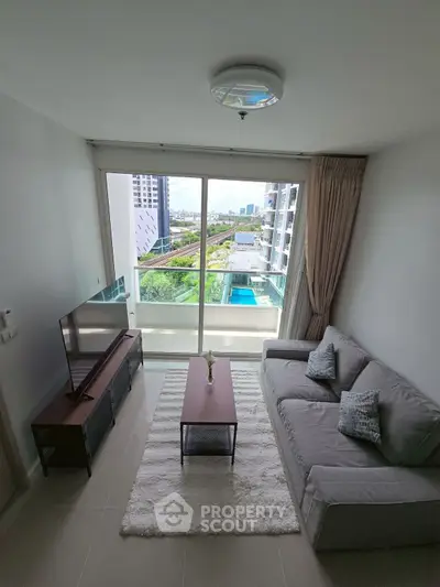 Modern living room with balcony view in high-rise apartment