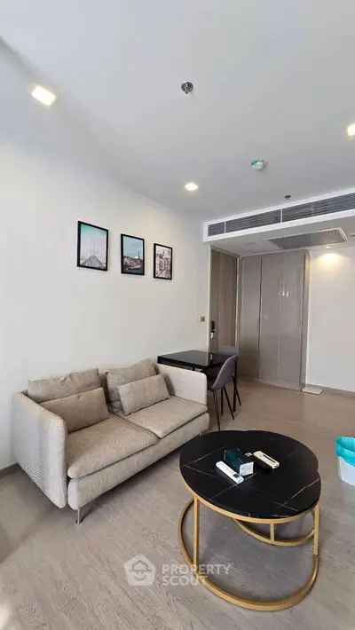 Modern living room with stylish furniture and wall art in a cozy apartment.