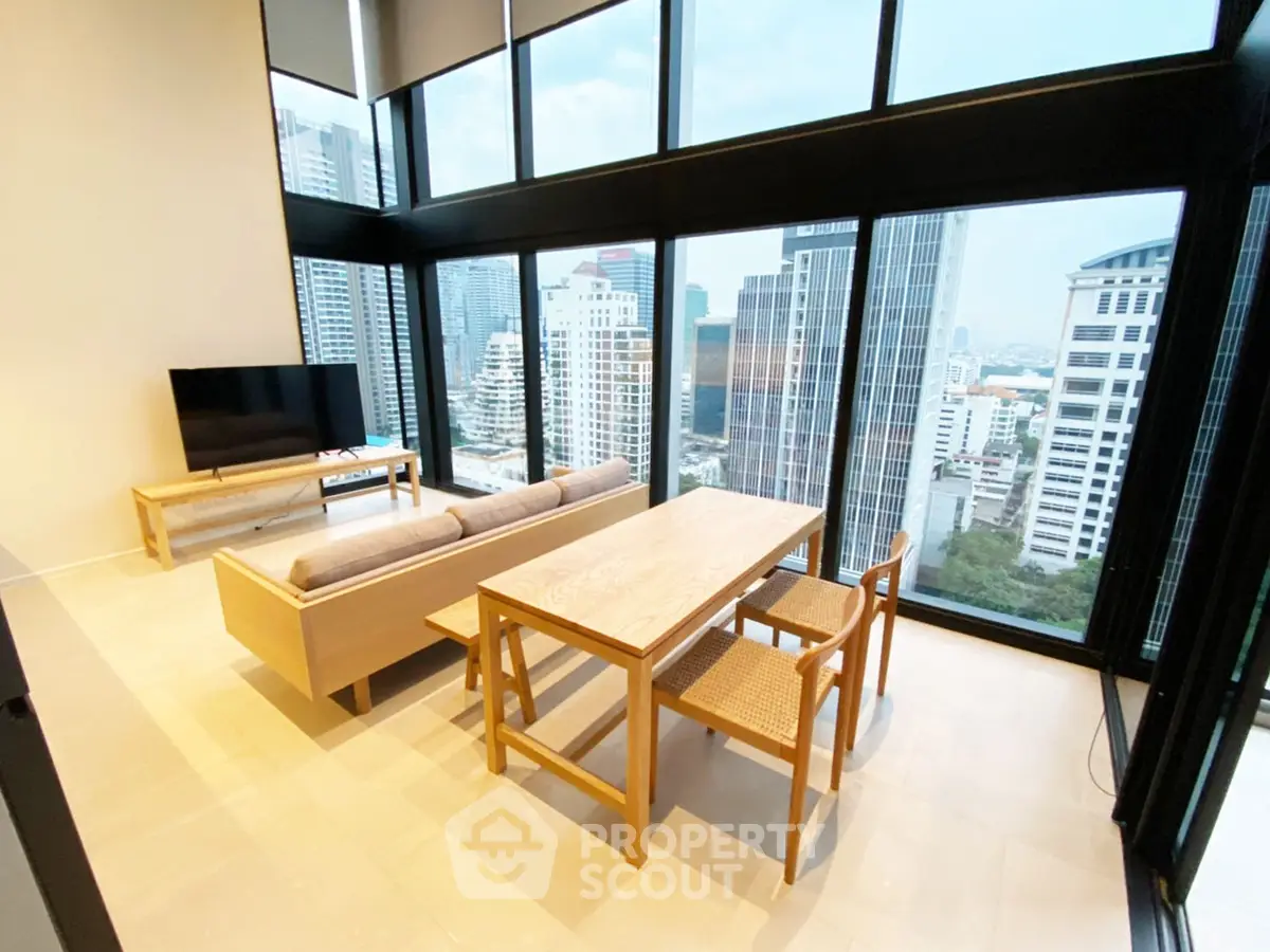 Stunning high-rise living room with panoramic city views and modern furnishings.