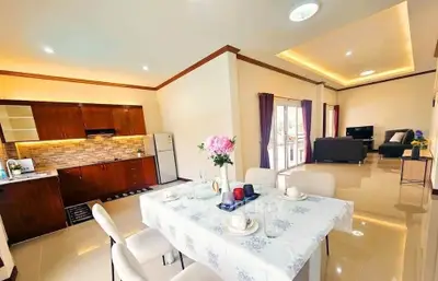 Spacious open-layout living and dining area with modern kitchen in a bright, elegant home.