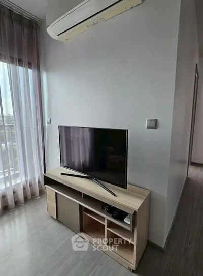 Modern living room with sleek TV stand and air conditioning unit