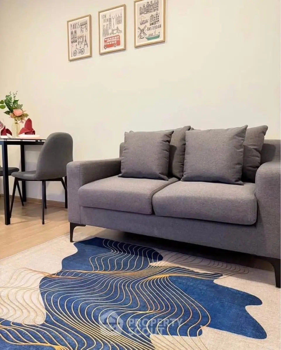 Modern living room with stylish grey sofa and abstract blue rug