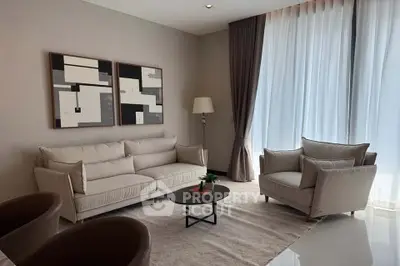 Elegant living room with modern furniture and large windows for natural light.