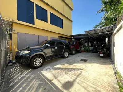 Spacious parking area beside a modern building with multiple vehicles parked