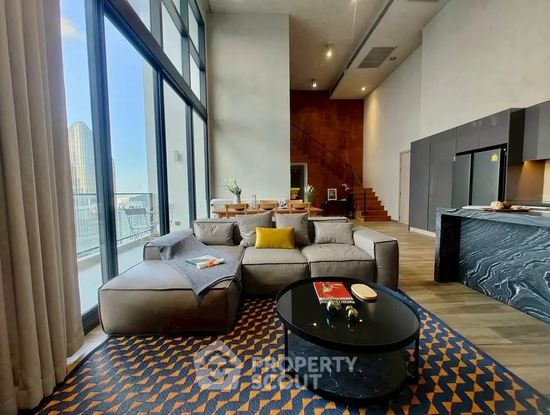 Luxurious modern living room with floor-to-ceiling windows and stylish decor