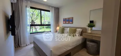 Modern bedroom with large window and stylish decor in a serene setting.
