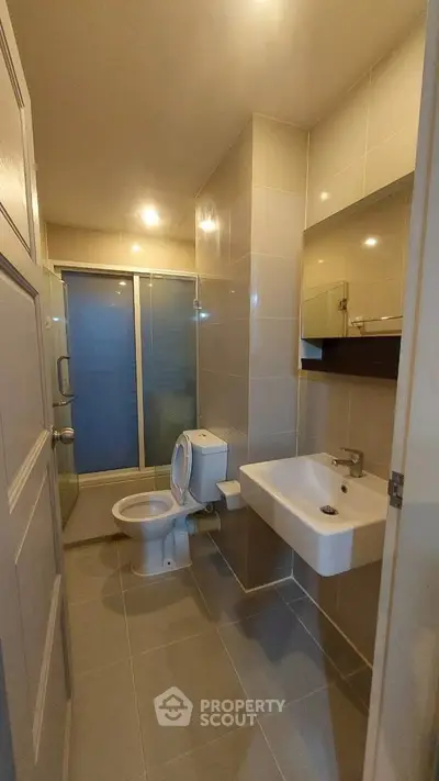 Modern bathroom with sleek fixtures and glass shower enclosure