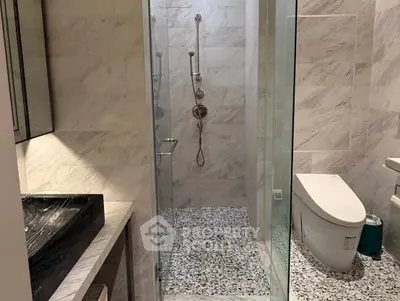 Modern bathroom with sleek design and glass shower enclosure