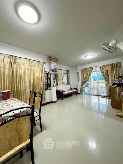 Spacious living room with elegant curtains and modern lighting