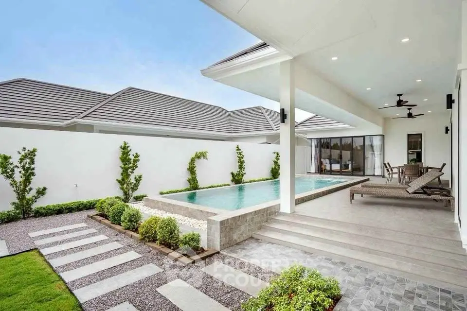 Luxurious modern home with private pool and stylish outdoor patio area.