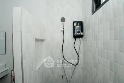 Modern bathroom with sleek shower and white tiled walls