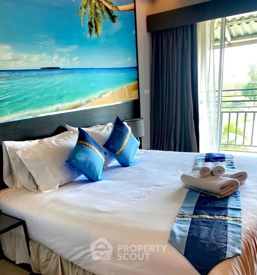 Luxurious bedroom with ocean-themed decor and balcony view