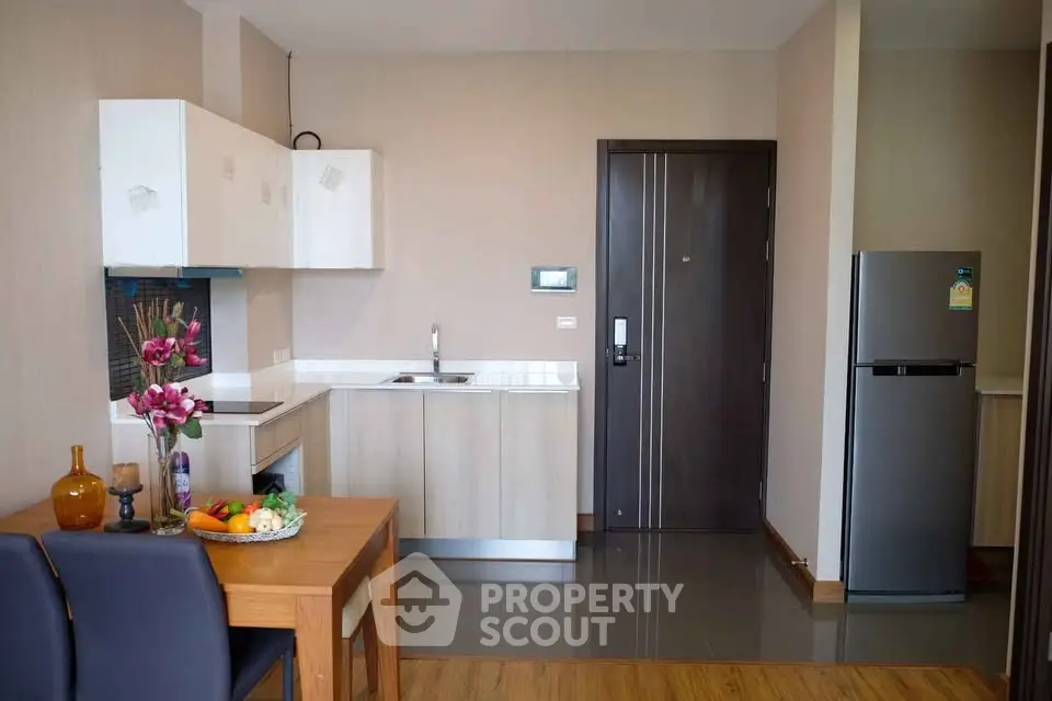 Modern kitchen with sleek cabinets and dining area in a stylish apartment