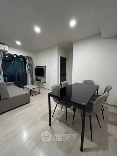 Modern living room with sleek dining area and large windows