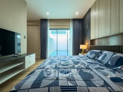 Modern bedroom with pool view and stylish decor
