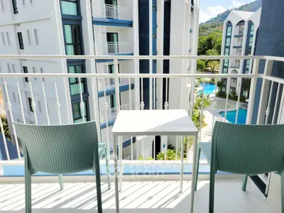 Charming balcony with pool view in modern apartment complex, perfect for relaxation and enjoying the scenery.