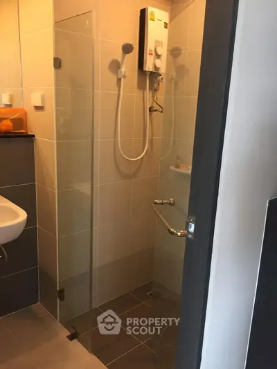 Modern bathroom with glass shower enclosure and water heater