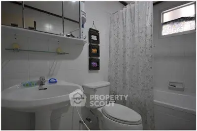 Cozy bathroom with modern fixtures and a bathtub, perfect for relaxation.