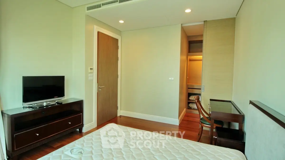 Spacious bedroom with modern furniture and natural light