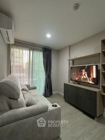 Cozy living room with modern decor and large window
