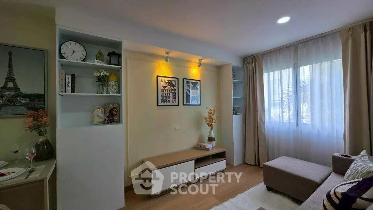 Charming living room with modern decor, cozy seating, and natural light from large window.