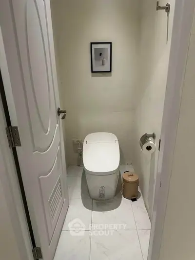 Compact bathroom with modern toilet and minimalistic decor