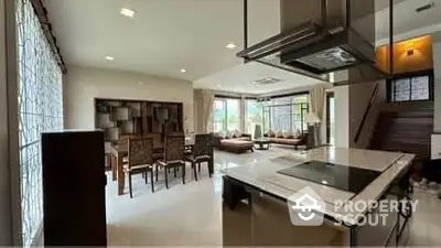 Spacious open-layout living room with modern kitchen and elegant dining area