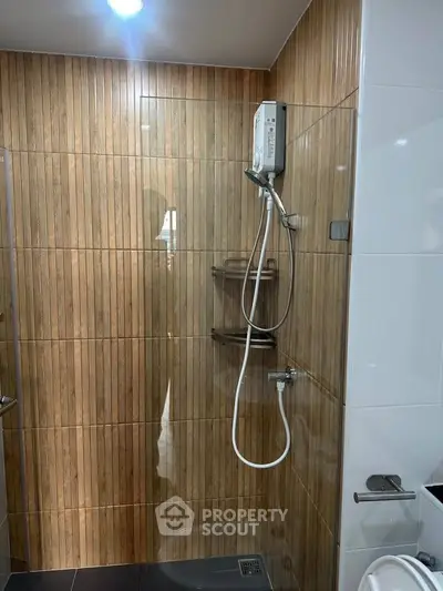 Modern bathroom with wood paneling and sleek shower design