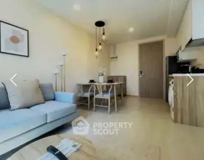 Modern living room with stylish decor and open kitchen layout, perfect for cozy urban living.