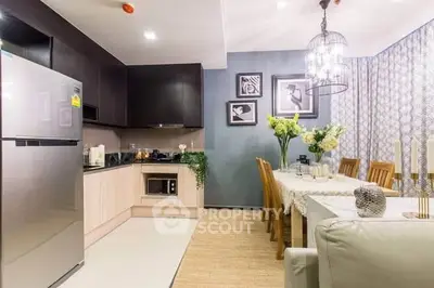 Modern kitchen and dining area with elegant decor and contemporary lighting.