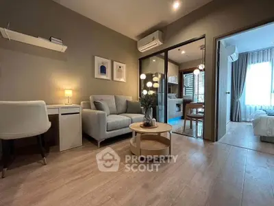 Modern living room with cozy sofa and stylish decor in open layout apartment.