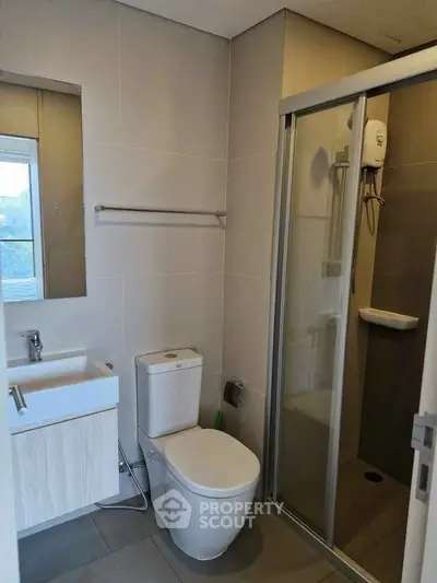 Modern bathroom with sleek fixtures and glass shower enclosure