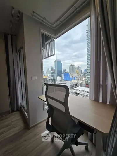 Modern study room with city view, featuring sleek desk and ergonomic chair, perfect for productivity.