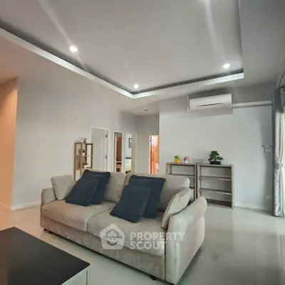 Spacious modern living room with plush sofa and sleek decor