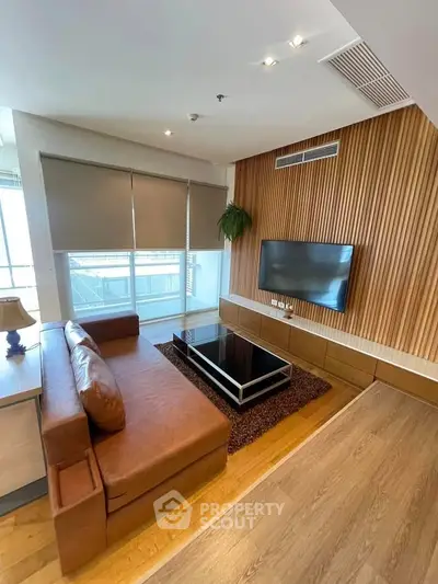 Modern living room with sleek wooden paneling and large windows for natural light.